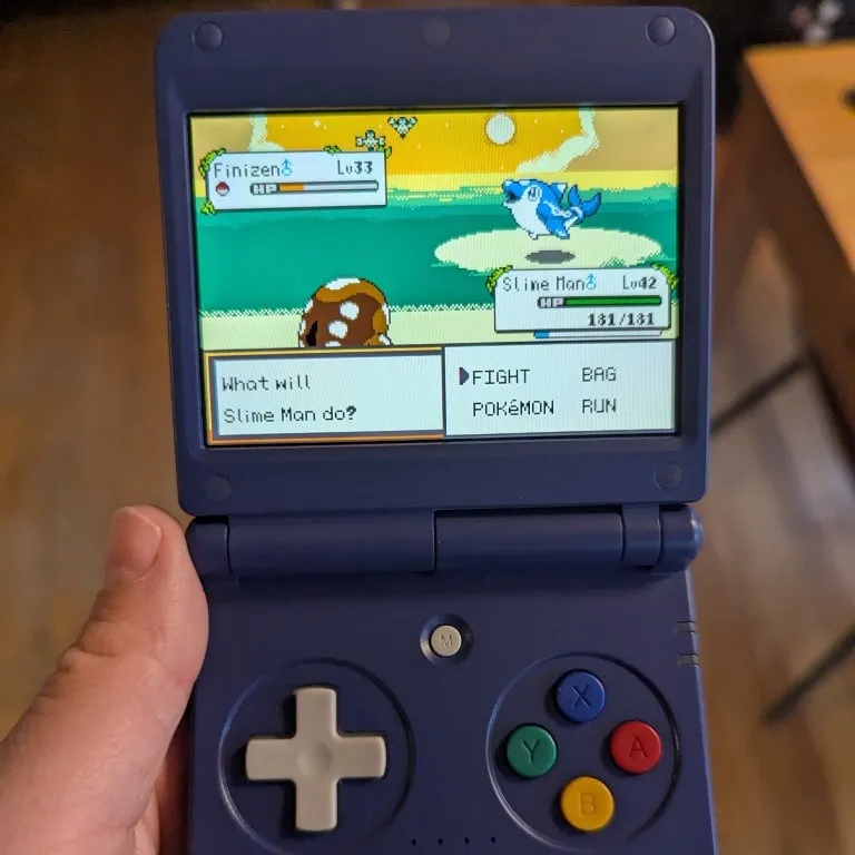 Me holding my Anbernic RG34XXSP with Pokémon Lazarus booted up.